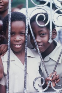 Two Jamaican schoolchildren. An official Jamaican Tourist Board photograph features two curious