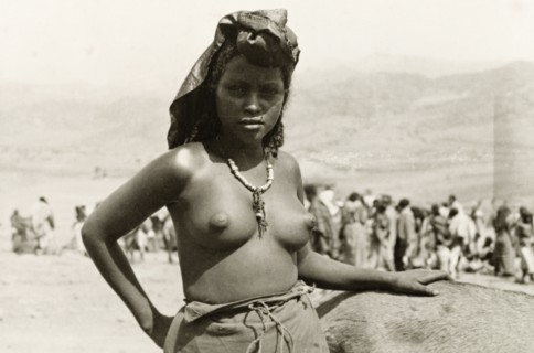 A young Eritean woman. Portrait of a young Eritean woman at a camel market. Naked from the waist