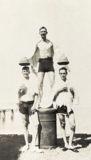 Hats off Brigadier Winthrop. Three European men pose for a comical photograph after a swim, wearing