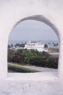 Elmina Castle from Fort St Jago. Distant view of Elmina Castle, taken through a cannon hole at Fort
