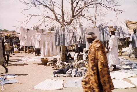 Smocks at Bolgatanga market. A range of smocks and textiles are displayed on a stall at Bolgatanga