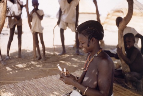 A Fulani woman uses hand spindles. A Fulani woman spins yarn using hand spindles. Kuka, Ghana,