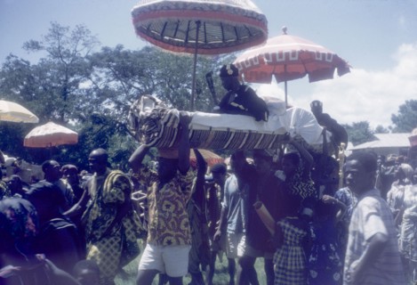 A Manya Krobo chief sits in a palanquin. A Manya Krobo chief sits in a palanquin beneath a