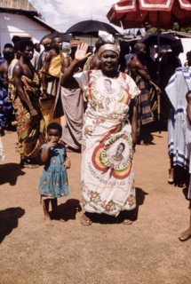 Independence cloth. A smiling woman wears a wrap-around cloth printed with the image of the