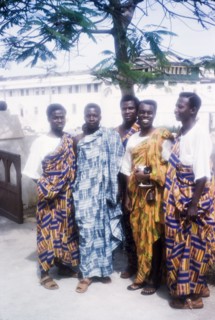 Men in traditional Ghanaian dress. A group of Ghanaian men pose for a portrait wearing traditional