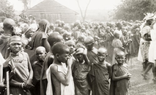 Children watching a performance, Kenya. A group of African children crowd together as they watch an