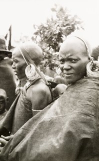 Portrait of two Kenyan women. Profile of two African women, one of whom carries a baby in a sling