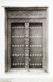 An ornate doorway in Kenya. An ornate wooden door in Lamu, decorated with studs and an intricately