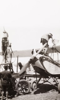 Refuelling an EAA aeroplane. Men refuel a East African Airways biplane at an airfield in Kenya.