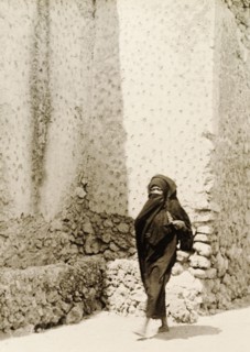 Woman in traditional Muslim dress. A woman wearing a traditional Muslim burqa walks along a street