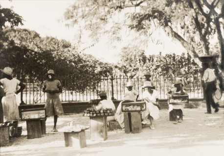 Jamaican street traders. Female street traders sell produce from trays and cases positioned on