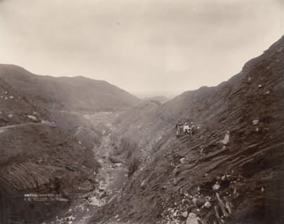American scientists below Soufriere. American scientists stand an altitude of 610 metres (2, 000