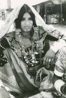 A woman wearing elaborate Indian jewellery. Seated portrait of an Indian woman, identified in an