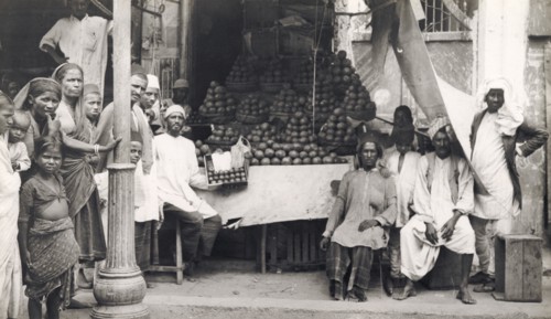 A vegetable stall in Hyderabad. Men, women and children pose for the camera beside a street stall