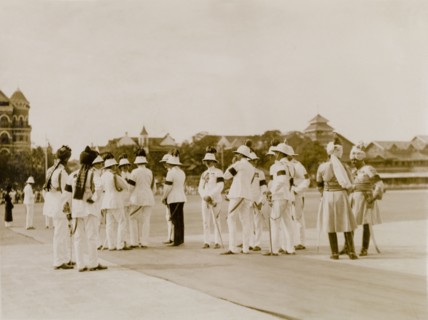 Awaiting the Earl of Reading's arrival. A number of uniformed aides-de-camp chat informally as they