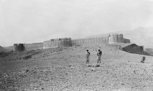 Fort wall in Kohistan . Two turbaned figures stand outside a hill fort in Kohistan, which features