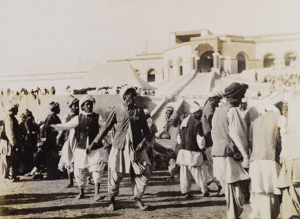 Male dancers in Sukkur. Male dancers perform to seated spectators at an outdoor event in Sukkur.