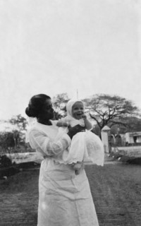 Indian ayah with Betty. An Indian ayah (nursemaid) called Nannie holds up a smiling four month old