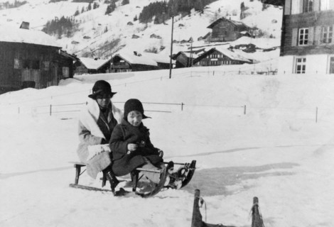 Indian ayah holidaying with family. An Indian ayah (nursemaid) called Nannie sits on a sledge with