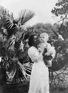 An Indian ayah with infant. An Indian ayah (nursemaid) called Nannie smiles as she holds up one