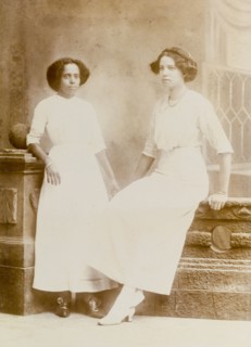 An Indian ayah poses with a European woman. Nannie, an Indian ayah (nursemaid), poses for a studio