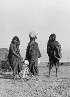 Indian women on a hilltop. Three traditionally dressed Indian women pose for a portrait on a
