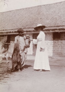 Phyllis Lawrence greets a farm worker's family. Phyllis Louise Lawrence, the first wife of Sir