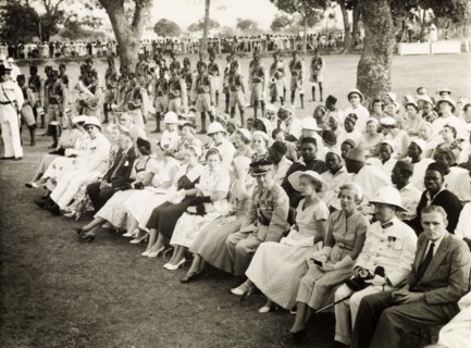 Awaiting Queen Elizabeth II's arrival. A seated assembly of African and European dignitaries await