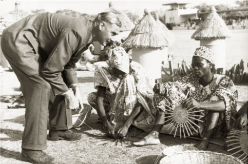 A basket-weaving demonstration. A European man visiting Kaduna Children's Village with Queen