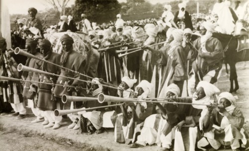 Nigerian trumpet players. A group of traditionally dressed Nigerian musicians assemble at an