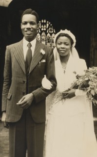 Titus and Oredola. A newlywed couple, Titus and Oredola, pose on the steps outside Freetown