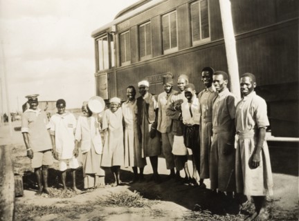Railway servants beside a private carriage. African railway servants pose for a group portrait
