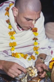Lighting a candle for Lord Krishna. A member of the International Society for Krishna