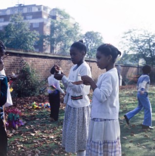 Lighting candles for Diwali. Two girls light candles outdoors to celebrate Diwali, the Hindu