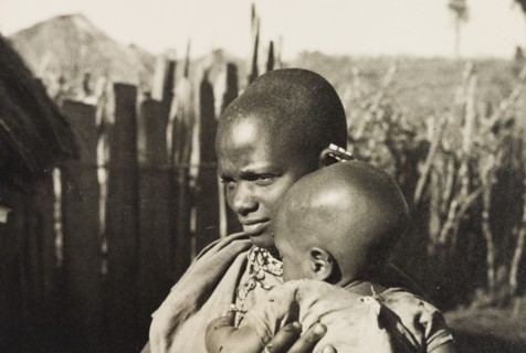 Kikuyu mother and baby. A Kikuyu baby is cradled by its mother, a woman identified in an original