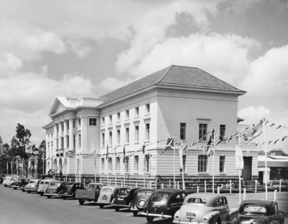 Decorations at Nairobi City Hall. Bunting hangs above a row of cars outside City Hall in