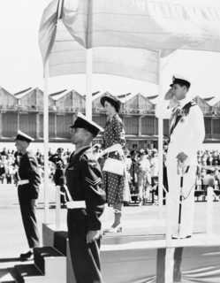 Taking the salute'. Princess Elizabeth and the Duke of Edinburgh stand on a dais to receive a
