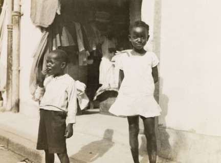 Two Jamaican children. Two young Jamaican children standing on a street in Kingston. Kingston,