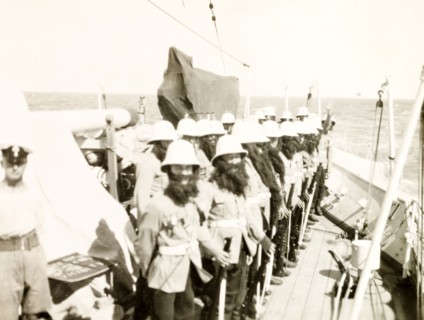 King Neptune's bodyguard. Crew members aboard the HMS Dauntless line up on deck dressed in fake