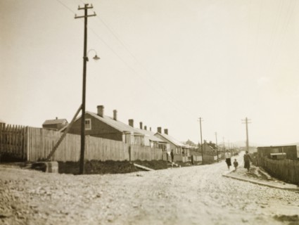 Stanley, East Falkland. View down a gravel road stretching past a row of colonial-style houses and