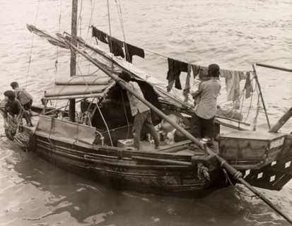 A Chinese family afloat. A Chinese family with three young children travel aboard a domestic sampan