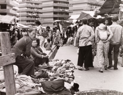 Clothes market in Hong Kong. Street traders display their wares at a busy clothes market. Behind