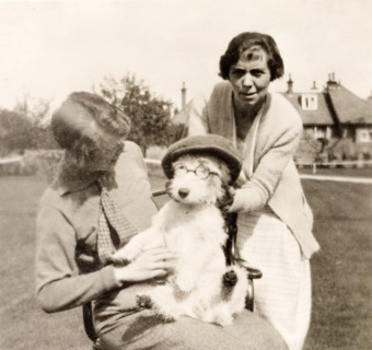 Dressing up the dog. Minnie Murray and her daughter dress up the family's pet dog in a flat cap and