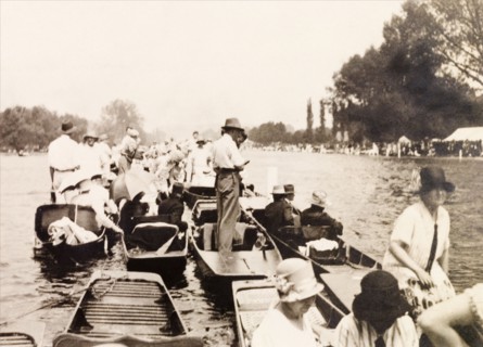 Henley Royal Regatta, 1929. Spectators gather on punts on the River Thames to watch a boat race at