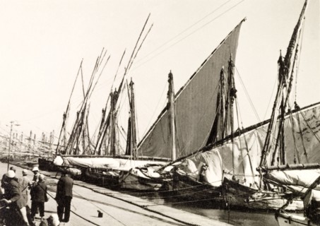 Docks on Suez Canal. Rows of sail boats are moored at docks on the Suez Canal. Suez, Egypt, 1930.