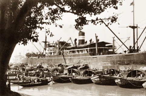 Moorings on the Hooghly River. Sampans moored on the Hooghly River are dwarfed by a European