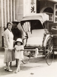 Posing with a rickshaw, Kuala Lumpur. A British woman and her daughter pose with a rickshaw during