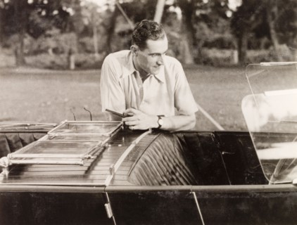 Posing by an Avion Voisin car. British colonist Noel Stokes poses by his Avion Voisin car as he