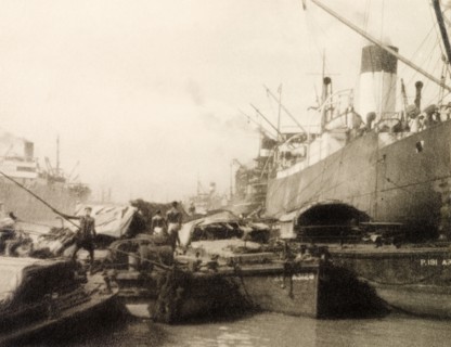 Vessels at Calcutta docks. River barges butt up against huge steamships at Calcutta docks on the