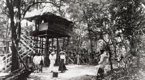 Mr Maduanwella's hut'. Two European women pose in front of 'Mr Maduanwella's hut' at an elephant